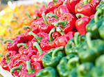 Yellow, orange, red and green peppers in wooden trays