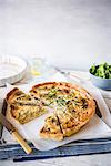 Carmelised onion and blue cheese quiche with rosemary, sliced with one slice removed