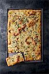 Four-cheese pizza on a baking tray