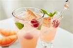 Paloma cocktails with grapefruit, raspberries, mint and ice