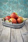 Fresh apples in a metal tray on a wooden table