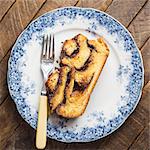 A slice of babka on a plate with a fork