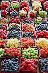 A market stand with fresh berries in cardboard punnets