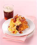 Scrambled egg and bacon on a Rösti (fried Swiss potato cake)