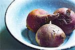 Three beetroot in an enamel bowl
