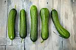 Five mini cucumbers in a row