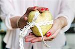 A woman's hands holding a heart-shaped potato