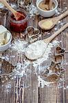 Ingredients for jammy shortbread biscuits: butter, flour, jam and demerara sugar