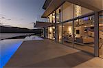 Tranquil modern luxury home showcase exterior with lap pool and dusk ocean view