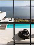 Modern luxury home showcase exterior infinity pool with sunny ocean view