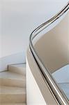 Stainless steel railing along spiral staircase in home showcase interior