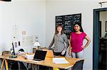 Portrait of colleagues in office looking at camera