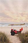 Lifeguard beach buggy on beach at sunset