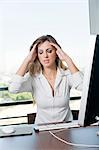 Woman with headache at office