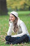 Portrait of a woman looking at camera sitting down in the Park