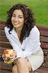 Businesswoman sitting in a bench in a Park in the pause from work