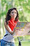 Woman with map and bicycle doing a tour