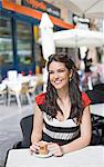 Portrait of a woman having a coffee outdoor smiling