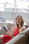 Portrait of a pretty blonde woman in a Cafe looking at a guidebook