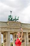 Pretty blonde woman doing sightseeing in Berlin