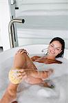 Young pretty brunette woman enjoying a bath