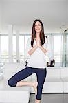 Healthy young woman doing yoga at home
