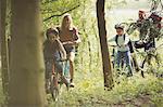 Family mountain biking in woods