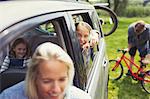 Portrait smiling girl with family inside car