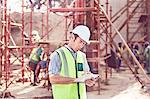 Construction worker using digital tablet at construction site