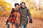 Affectionate couple walking on path in autumn park