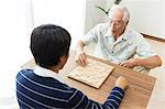 A father and son playing shogi