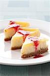 Mini cheesecakes on white plate with raspberry sauce, English Meadows Inn, Kennebunk, ME.