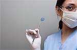 Dentist holding a piece of dental equipment