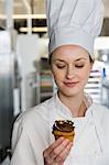 Baker holding cupcake