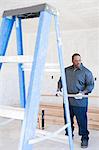 A builder holding a plank of wood