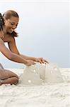Mother and daughter making sandcastles