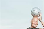 Man putting basketball on his head