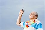 Senior man taking a photograph