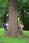 Teenage friends spending time together at tree