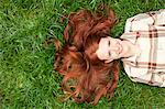 Teenage girl laying in grass