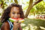Portrait of young girl eating watermelon