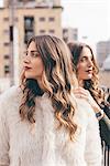 Twin sisters, outdoors, looking away