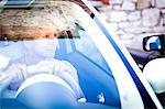 Smiling mature woman looking through car windscreen