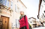 Woman in street looking away. Bruniquel, France