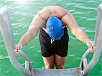 Swimmer on ladder into water, Eastern Beach, Geelong, Victoria, Australia