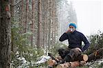 Logger taking break on logs, Tammela, Forssa, Finland