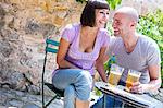 Couple enjoying beer in garden, Mallorca, Spain