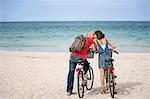 Couple on bicycles on the beach, Mallorca, Spain