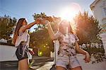 Teenage girls having fun in residential street, Cape Town, South Africa