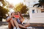 Teenage girls having watermelon in street, Cape Town, South Africa